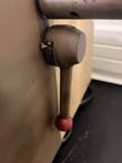 Lever with a red ball handle and scale on the Burrell wrist action shaker