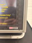 Lower corner of the HDI CR-2000 screen bezel with yellow startup text and Hypertension Diagnostics logo label