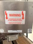 Hazardous voltage warning label, oven fan fuse label and reset buttons on the Lincoln Impinger oven control housing