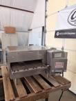 Front three-quarter view of Lincoln Impinger 1301 conveyor pizza oven on a wooden pallet, conveyor belt extended