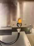 Orange-handled water drain valve and black hose under the Groen INTEK steamer