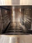 Inside the Groen steamer cooking chamber, showing side rack rails and the perforated INTEK steam plate