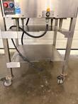 Lower half of Groen INTEK steamer: two-shelf stainless stand on locking casters, controls and orange drain valve