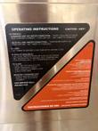 Bilingual English and Spanish operating instructions decal on the Groen steamer door