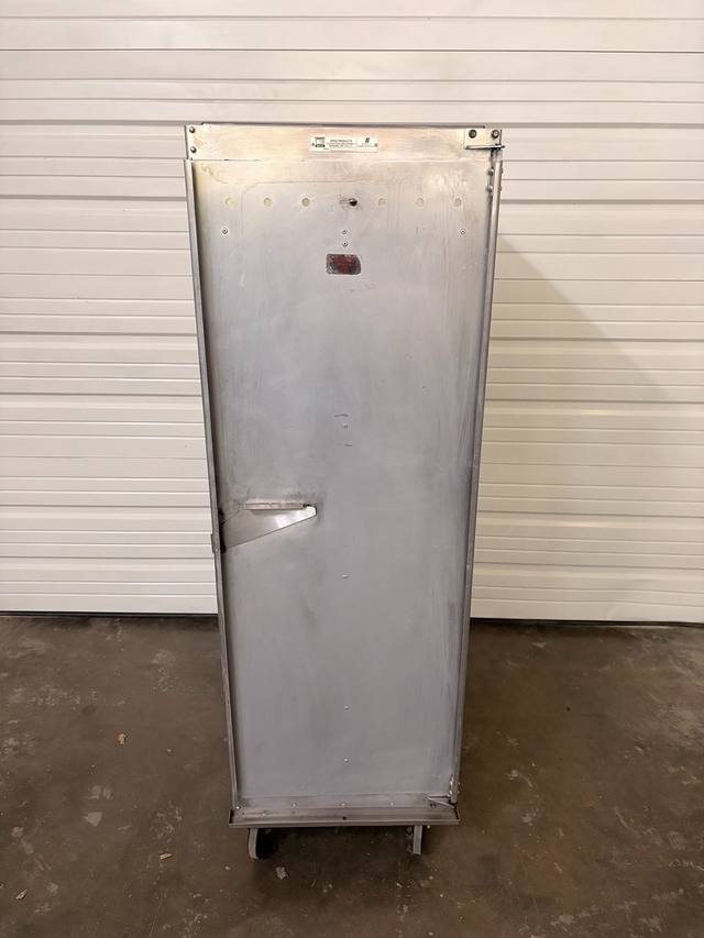 Front of EPCO holding and proofing cabinet on casters, closed aluminum door with latch and EPCO plate at top