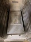 Top of the heater box at the bottom of the EPCO cabinet, between the pan slides
