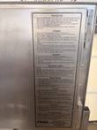 English and Spanish operating instruction plate on the steamer door