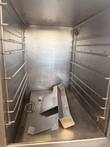 Inside the AccuTemp steamer: wire racks on both walls and a stainless water tray on the floor