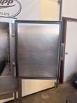 Open stainless steamer door with black gasket and latch, cooking chamber rack visible at left