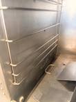 Wire pan racks and a small pull handle on the floor of the AccuTemp steamer chamber