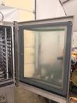 Inside of the open oven door showing the fogged inner glass panel and gray gasket