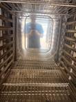 Inside the oven cavity looking down the side rack rails to wire racks at the bottom