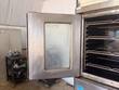 Open Blodgett oven door with glass window and racks beside it