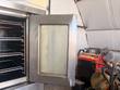 Open Blodgett oven door with glass window and racks beside it