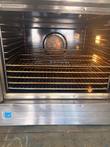 Open oven cavity with five wire racks, rear convection fan and lit interior lamps, Energy Star label below