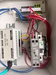 IDEC PS5R-VC12 30 W power supply beside terminal blocks and wiring in the control enclosure