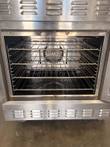 Lower Lang oven cavity with four stainless wire racks and the convection fan