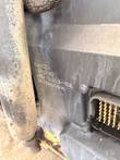 Etched identification text on the black engine control module beside its multi-pin connector
