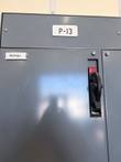 Upper door of the gray motor control center unit with P-13 label and black red-tagged disconnect handle