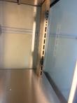 Empty stainless steel floor and slotted shelf-rack rail inside the Hatco display cabinet