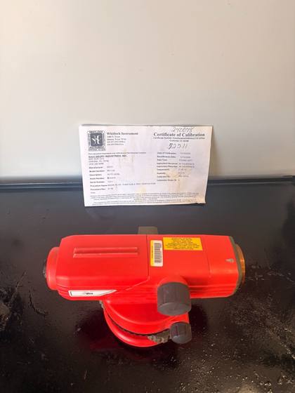 Red SECO automatic level on a black tray with its Whitlock Instrument certificate of calibration behind it