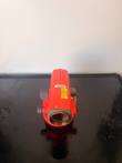 Red automatic level seen from the front lens end on a black tray, with Toolwatch barcode and calibration label