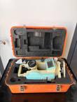 Leica LDT-05 digital theodolite resting in its open orange hard case with foam cutouts and a silica gel packet