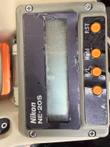Nikon NE-20S display panel with worn faceplate and four orange buttons, photographed sideways