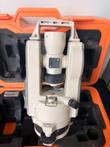Nikon NE-20S theodolite in open orange case, telescope, handle and leveling base visible