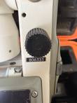 Nikon NE-20S theodolite side post with black clamp knob and serial plate 806333, orange case behind