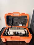Nikon NE-20S electronic theodolite resting in its open orange hard case with foam inserts