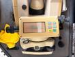DWT-10 theodolite display reading zero angles, with R/L, V/%, HOLD and OSET buttons and tribrach below