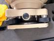 DWT-10 tribrach base with black leveling knobs and locking pin, close-up