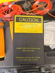 Black module with yellow caution label about laser light and a note for use with Corning VFL-350