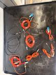 Orange fiber patch cords with ST and SC connectors and a black serial cable laid out on a black case lid