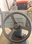 Steering wheel and dash of the Nilfisk Liberty SC60 with touchscreen at left and control panel at right