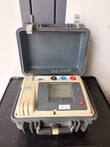 Megger MIT510/2 5kV insulation tester in an open gray hard case, display and three terminals visible