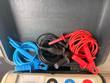 Red, black and blue insulation test leads coiled inside the case lid