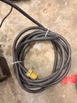 Coiled black power cord with a yellow plug