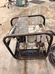 Hydraulic torque wrench pump from the side, steel frame, gauge, motor and blue reservoir