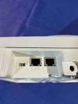 White wireless access point showing two LAN ports and a power connector, on a blue background