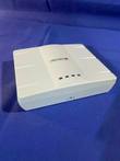 Enterasys wireless access point on blue fabric with four indicator lights on top