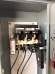 Square D 30A disconnect inside open enclosure with L1, L2 and L3 terminals and three black wires