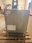 Back of Follett refrigerator with data label, wiring diagram label, lower vent grille and power cord