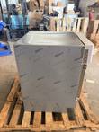 Side of Follett undercounter refrigerator covered in Nitto protective film, on a pallet