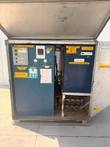 Open 10-ton chiller with blue control panels, pressure gauges, temperature controller and valve manifold; 30A 480V label