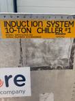 Orange label reading Induction System 10-Ton Chiller #1, model SMN75002-01, on an aluminum enclosure