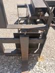 Pallet fork frame corner with one tine and the quick-attach carriage plate behind it