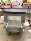 Beseler shrink tunnel end view with open-mesh conveyor belt, white curtains and caster wheels