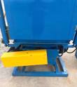 Blue shot blast cabinet base with yellow drive guard, motor and steel skid frame